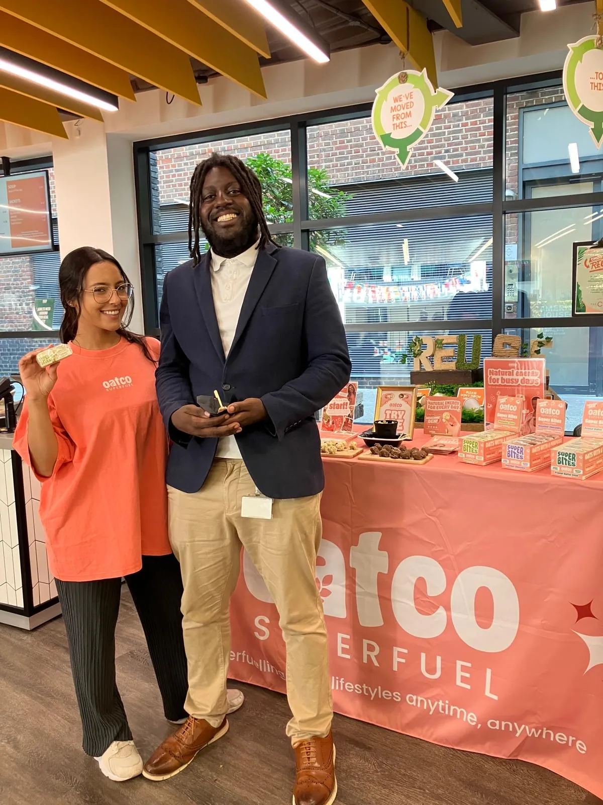 FOTS ambassador and a visitor tasting Oatco Superfuel in front of the branded sampling table